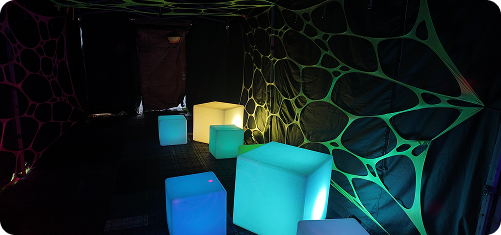 Rave Cave interior with illuminated furniture and fluorescent wall decorations